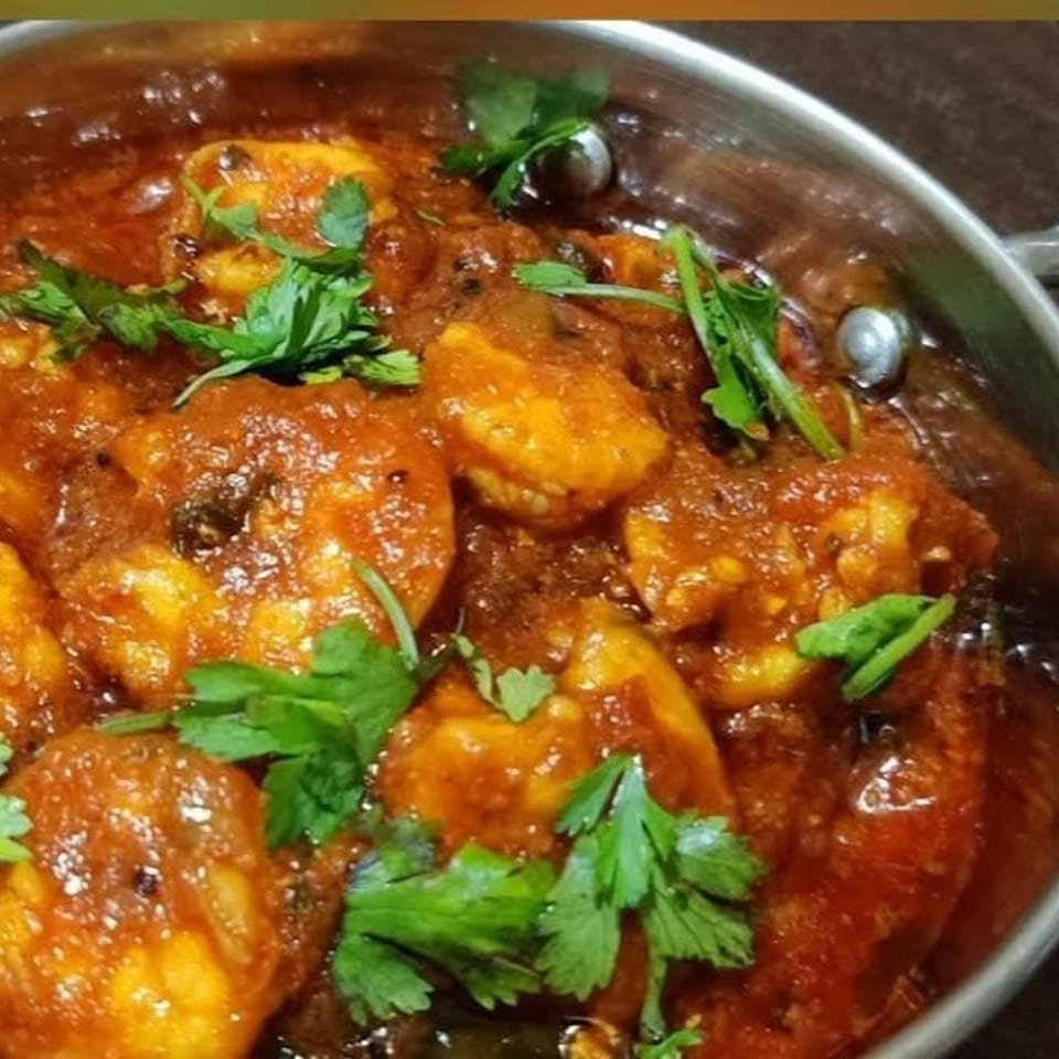 Shrimp in red curry garnished with cilantro.